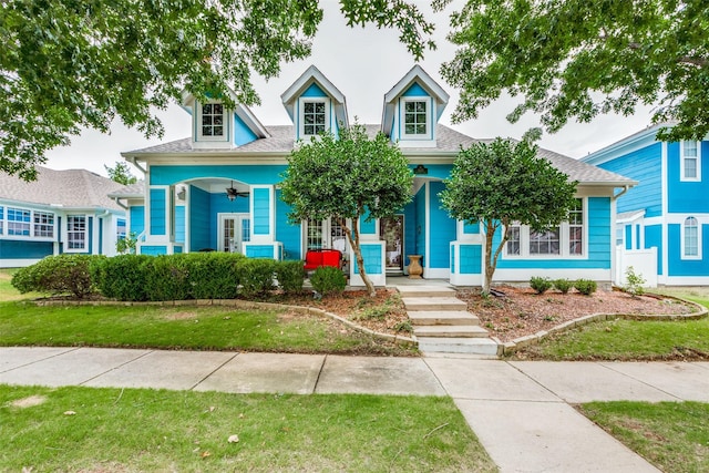 new england style home with a porch and a front yard