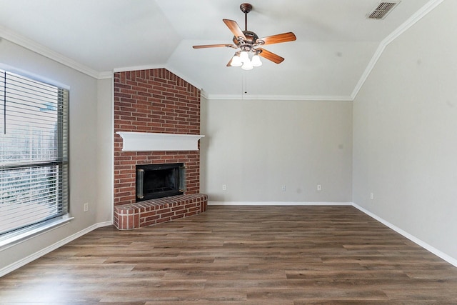 unfurnished living room with crown molding, ceiling fan, dark wood-type flooring, a fireplace, and lofted ceiling