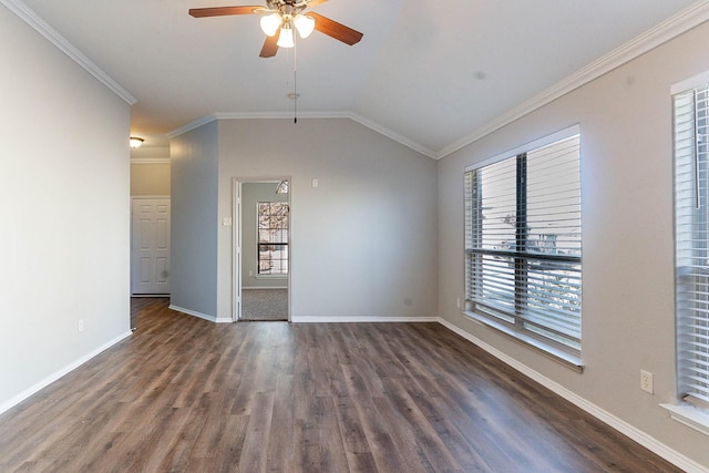 empty room featuring lofted ceiling, dark hardwood / wood-style flooring, ceiling fan, and crown molding