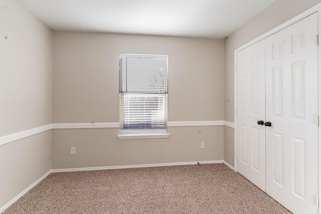 unfurnished bedroom with a closet and carpet