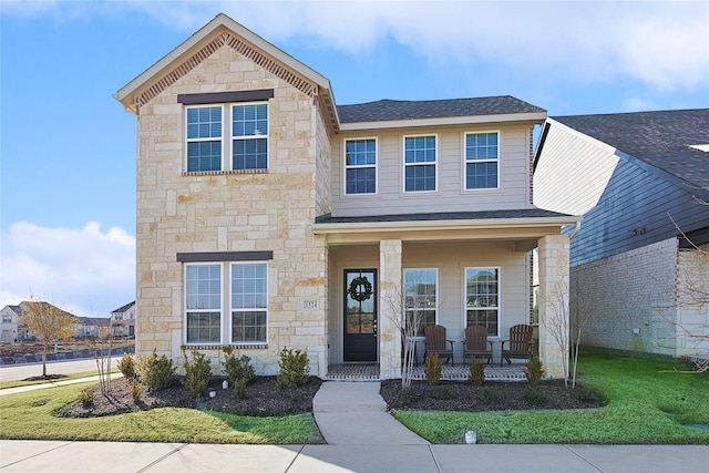 1524 Trailblazer Way, Northlake, TX 76247 - view of front of home featuring stone siding, a porch, a shingled roof, and a front yard