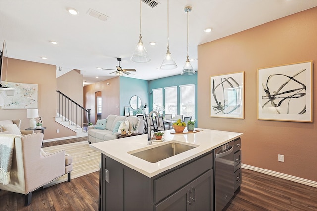 kitchen with dishwasher, pendant lighting, a kitchen island with sink, ceiling fan, and sink