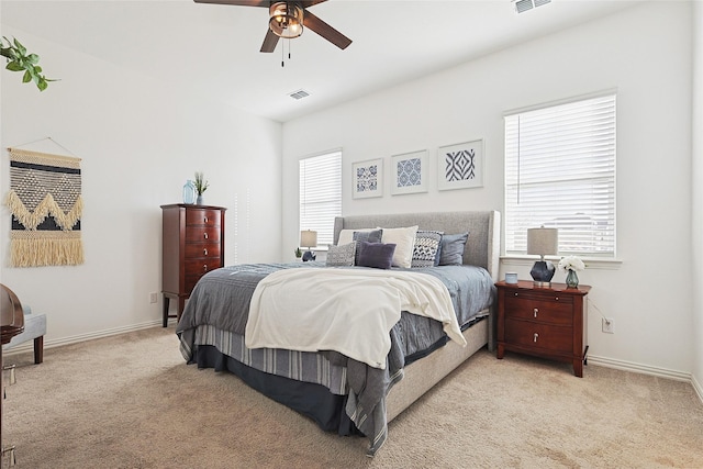 bedroom featuring ceiling fan and light carpet