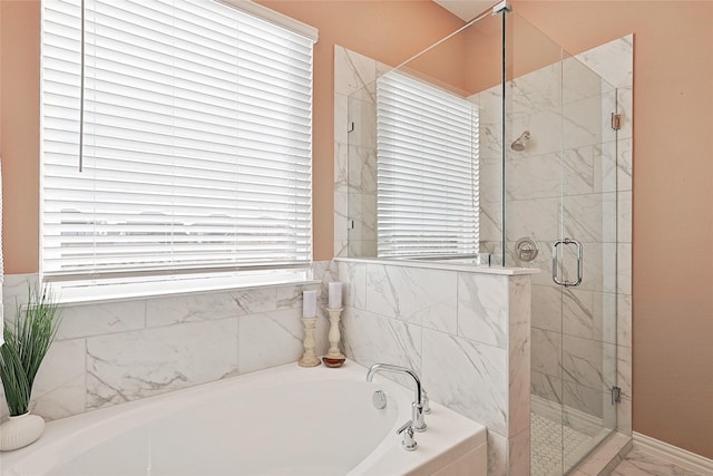 bathroom featuring a healthy amount of sunlight and independent shower and bath