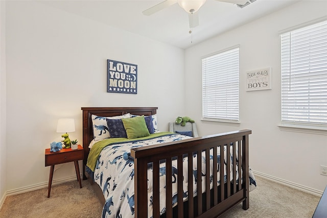 bedroom with multiple windows, ceiling fan, and carpet