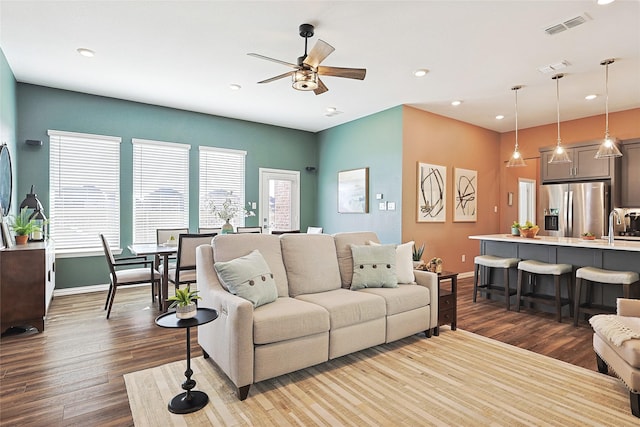 living room with sink, hardwood / wood-style floors, and ceiling fan