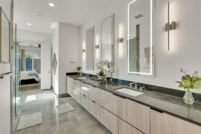 bathroom featuring ceiling fan and vanity