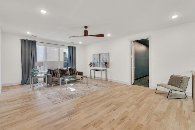 living room featuring ceiling fan and light wood-type flooring