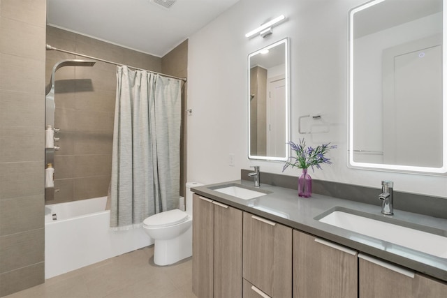 full bathroom featuring shower / bath combination with curtain, tile patterned floors, vanity, and toilet