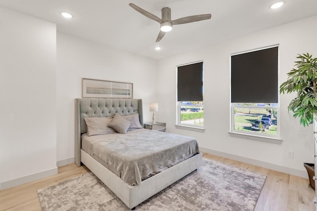 bedroom with ceiling fan and light hardwood / wood-style floors