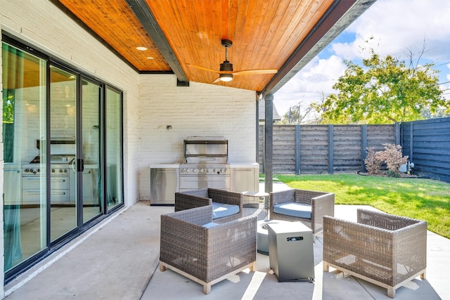 view of patio featuring ceiling fan, grilling area, exterior kitchen, and outdoor lounge area