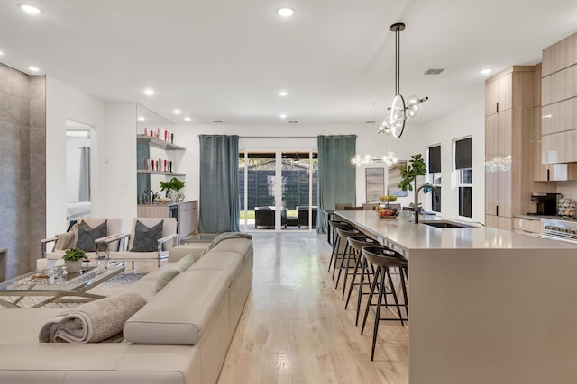 living room with light wood-type flooring and sink