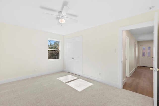 carpeted empty room with ceiling fan