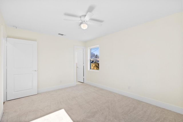 carpeted empty room featuring ceiling fan