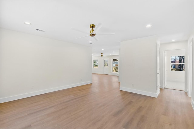 unfurnished living room featuring ceiling fan and light hardwood / wood-style floors