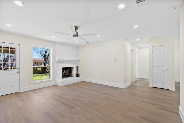 unfurnished living room with ceiling fan and light hardwood / wood-style floors