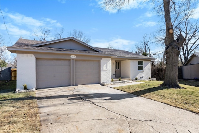 ranch-style home featuring a front lawn and a garage