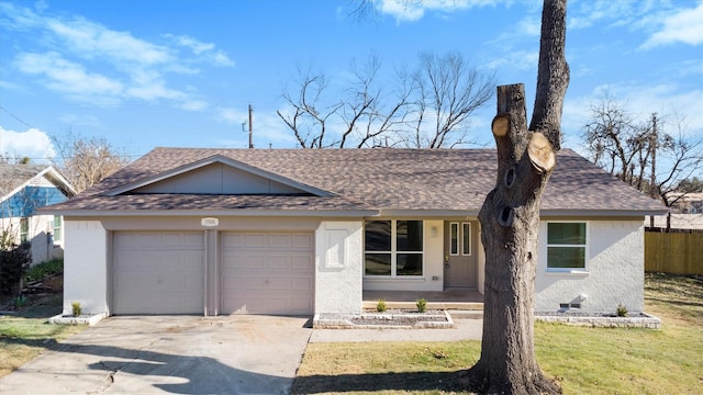 ranch-style home with a front lawn and a garage