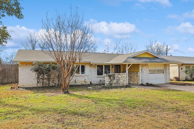 ranch-style home with a front yard and a garage