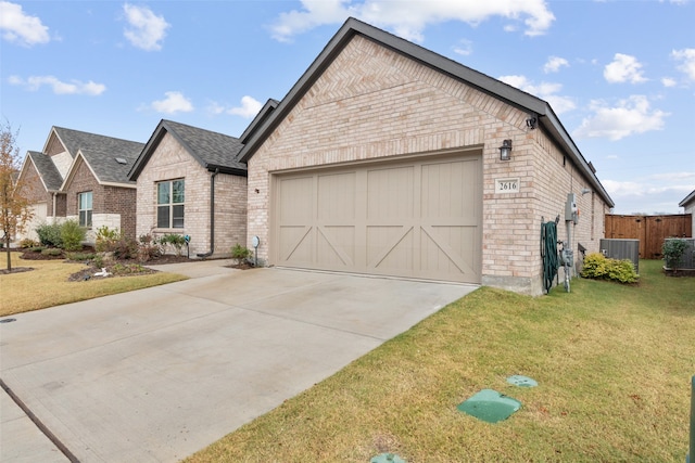 view of front of home featuring brick siding, central air condition unit, a front yard, a garage, and driveway