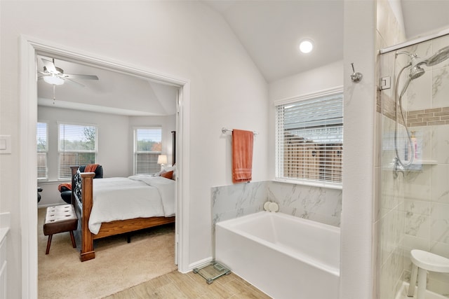 full bath featuring ceiling fan, vaulted ceiling, a shower stall, ensuite bath, and a bath