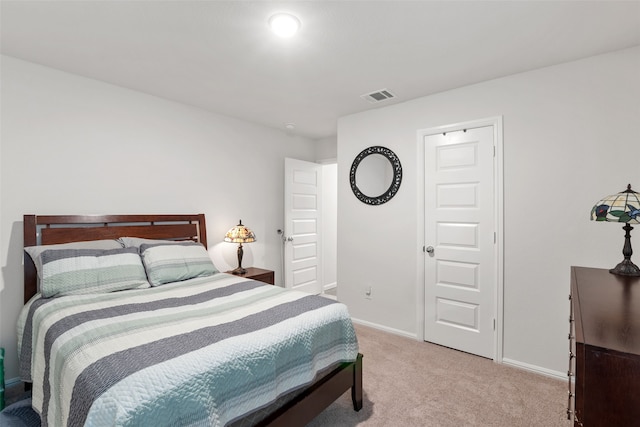 bedroom featuring light carpet, baseboards, and visible vents