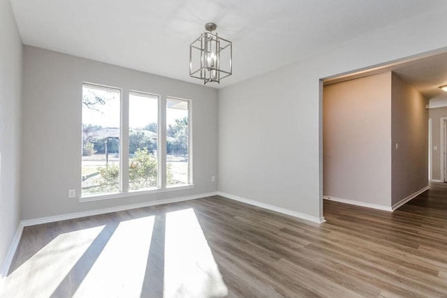 unfurnished dining area with dark hardwood / wood-style flooring and a chandelier