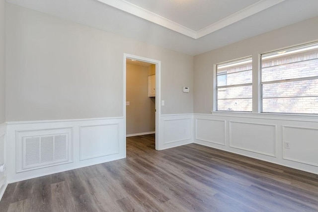 unfurnished room featuring ornamental molding and dark wood-type flooring