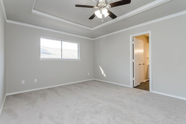 unfurnished room featuring carpet floors, ornamental molding, and a tray ceiling