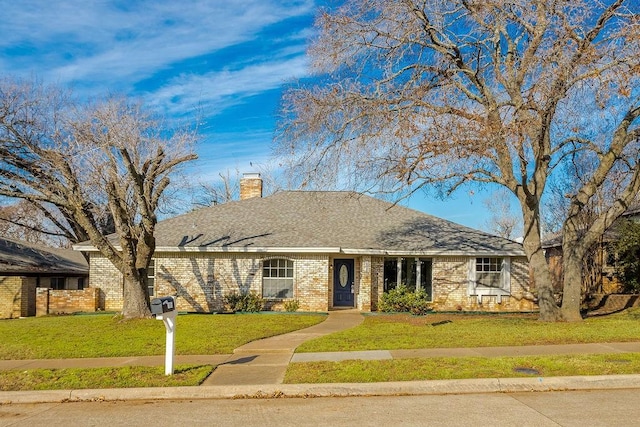 ranch-style home featuring a front yard