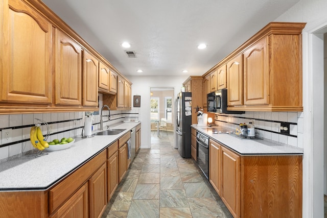 kitchen with sink, tasteful backsplash, and appliances with stainless steel finishes