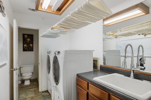 laundry room featuring sink and washing machine and clothes dryer