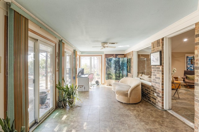 sunroom / solarium featuring ceiling fan