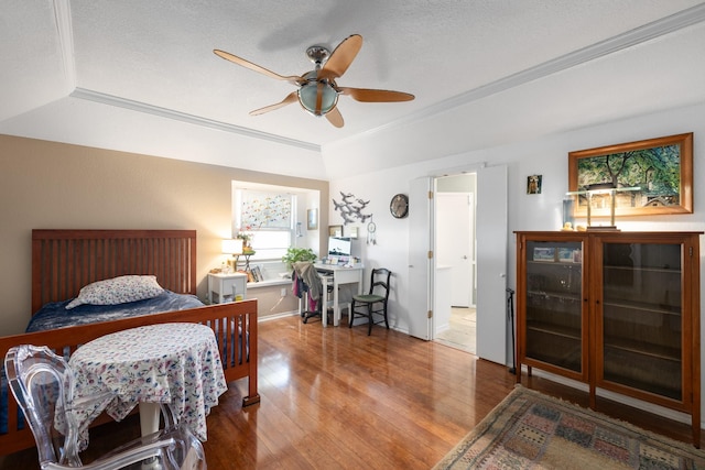 bedroom with ceiling fan, hardwood / wood-style flooring, and ornamental molding