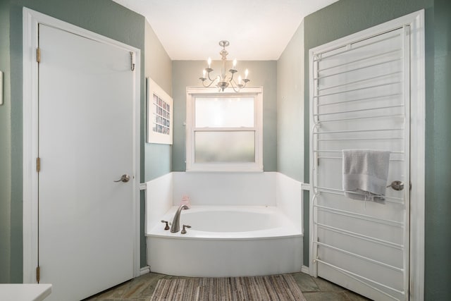 bathroom with a tub and a chandelier