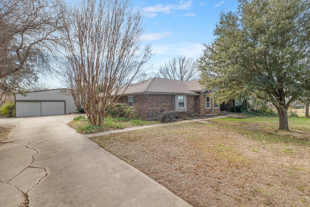 single story home with a front yard and a garage