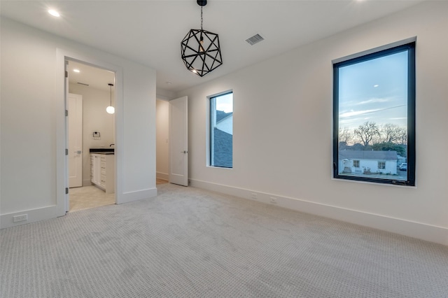 unfurnished room with light carpet