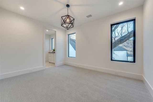 spare room featuring light colored carpet