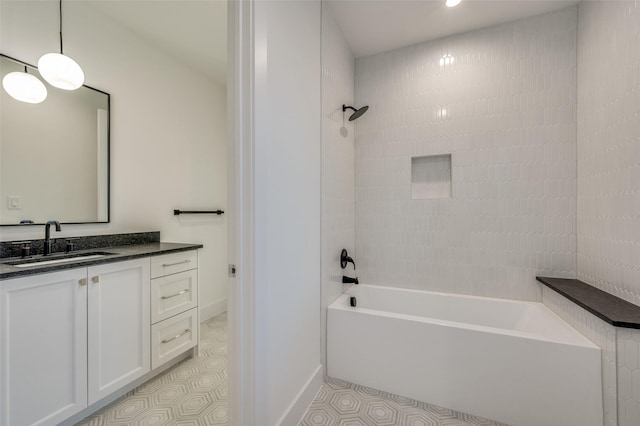 bathroom featuring tiled shower / bath and vanity