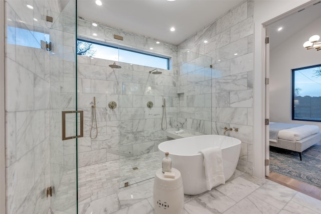 bathroom featuring lofted ceiling and separate shower and tub