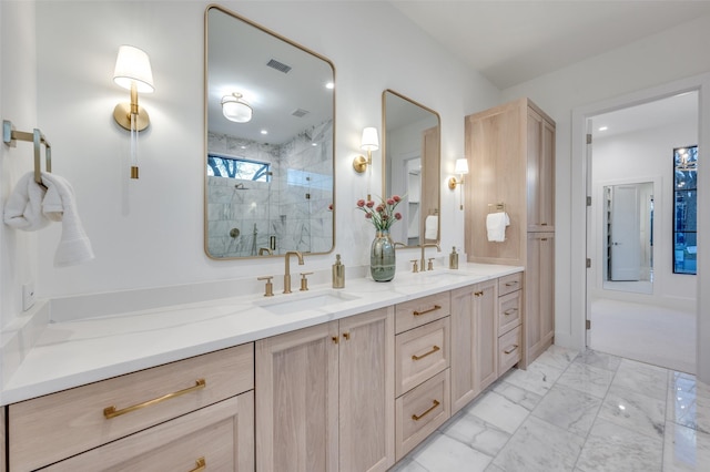 bathroom featuring a shower with door and vanity