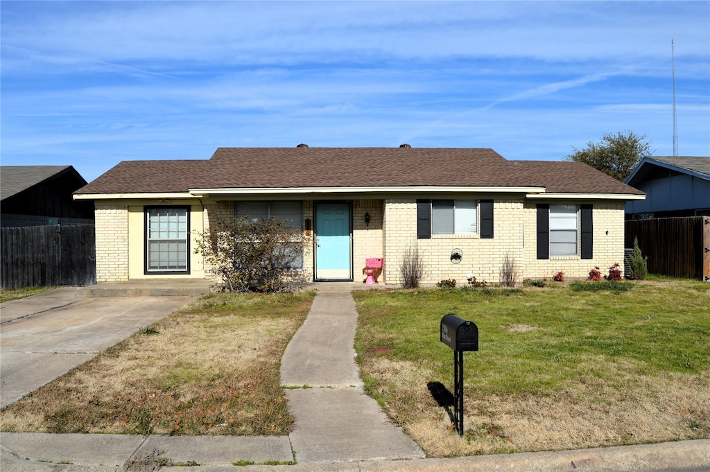 ranch-style house with a front lawn