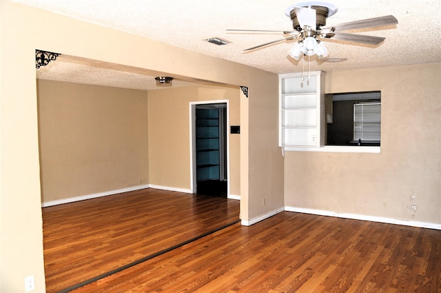 empty room featuring a textured ceiling, hardwood / wood-style floors, and ceiling fan