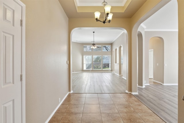 interior space featuring light tile patterned flooring, a chandelier, and ornamental molding