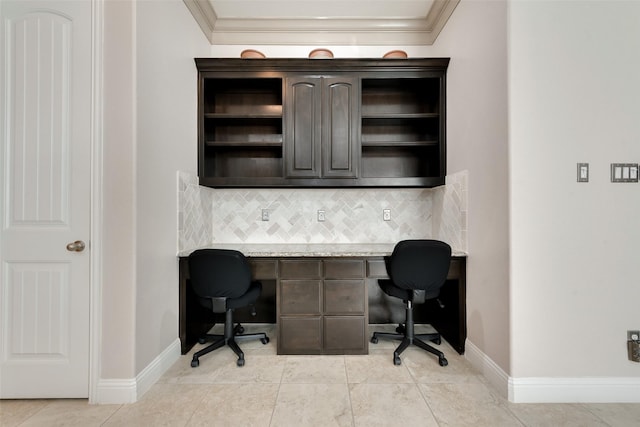 tiled office space with built in desk and crown molding