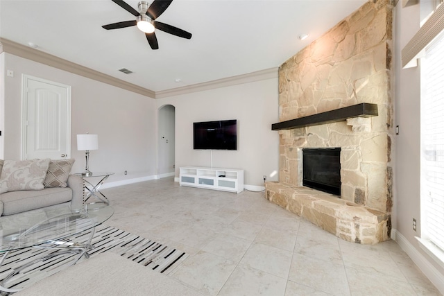 unfurnished living room featuring ceiling fan, ornamental molding, and a fireplace