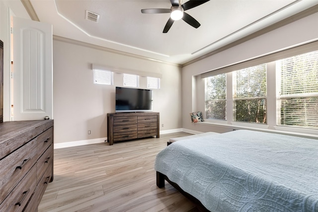 bedroom with ceiling fan, light hardwood / wood-style floors, and ornamental molding