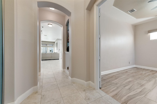 hall with light tile patterned floors