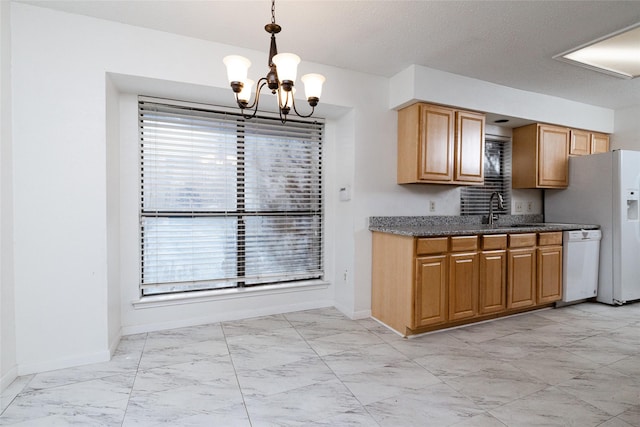 kitchen featuring a chandelier, dishwasher, pendant lighting, and sink