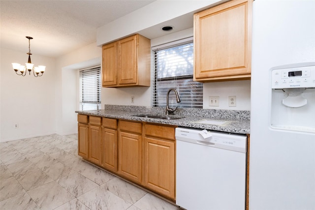 kitchen featuring white appliances, light stone counters, a chandelier, hanging light fixtures, and sink